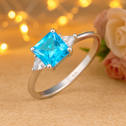 Blue Princess Cut Ring with Sparkling Side Stones